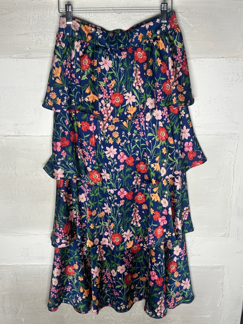 New with tags. Tiered ruffle floral skirt skies are Blue. Size medium
